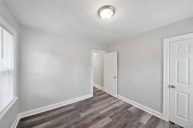 4835 Bedford St, Detroit, MI 48224 - unfurnished bedroom with dark wood finished floors and baseboards