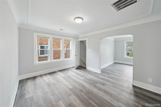 4835 Bedford St, Detroit, MI 48224 - empty room with arched walkways, wood finished floors, and baseboards