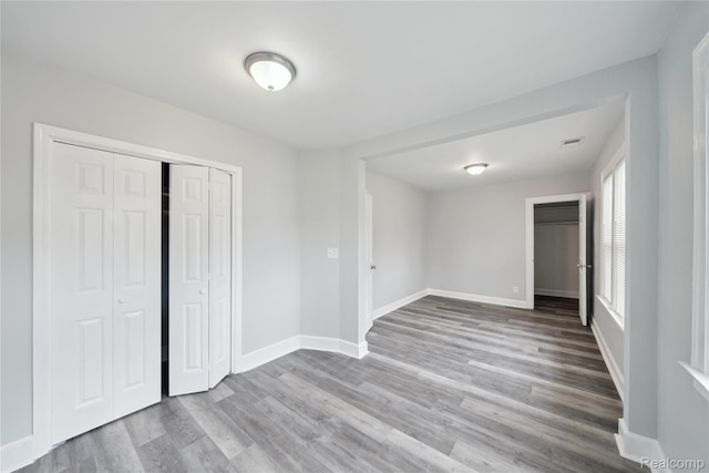 4835 Bedford St, Detroit, MI 48224 - unfurnished bedroom featuring wood finished floors, baseboards, and a closet