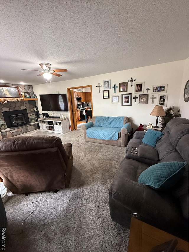 3454 Pine St, Hale, MI 48739 - carpeted living area with a stone fireplace, a ceiling fan, and a textured ceiling
