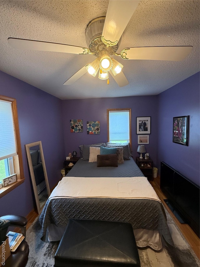 3454 Pine St, Hale, MI 48739 - bedroom featuring multiple windows, wood finished floors, and ceiling fan