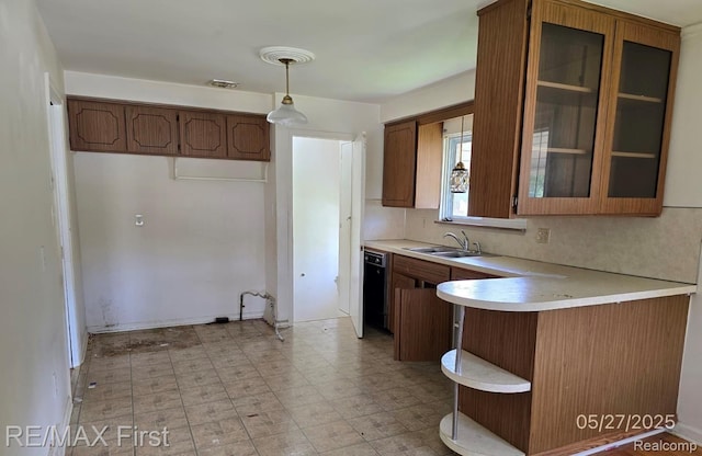 7210 Weingartz, Center Line, MI 48015 - kitchen featuring a sink, a peninsula, light countertops, black dishwasher, and glass insert cabinets