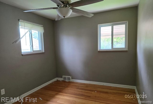 7210 Weingartz, Center Line, MI 48015 - empty room with plenty of natural light, baseboards, wood finished floors, and a ceiling fan