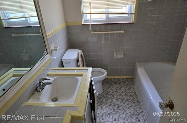 7210 Weingartz, Center Line, MI 48015 - full bath with toilet, plenty of natural light, tile walls, a tub, and tile patterned floors
