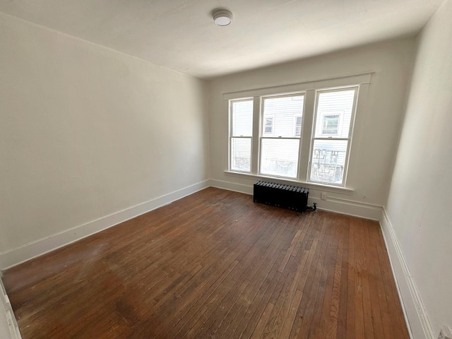 320 W Vine St, Kalamazoo, MI 49001 - unfurnished room featuring radiator, dark wood finished floors, and baseboards