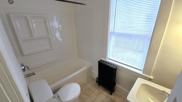 320 W Vine St, Kalamazoo, MI 49001 - bathroom with radiator, toilet, washtub / shower combination, tile patterned flooring, and baseboards