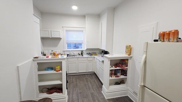 320 W Vine St, Kalamazoo, MI 49001 - kitchen featuring freestanding refrigerator, white cabinets, dark wood-style flooring, and a sink