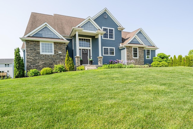 1640 Prairie Dr, Saint Joseph, MI 49085 - view of front of property featuring stone siding, a front lawn, and roof with shingles