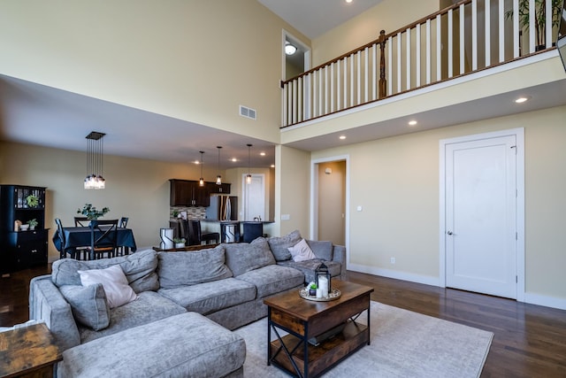 1640 Prairie Dr, Saint Joseph, MI 49085 - living area featuring dark wood-style floors, a high ceiling, baseboards, and recessed lighting