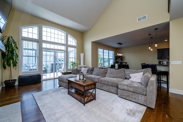 1640 Prairie Dr, Saint Joseph, MI 49085 - living room with high vaulted ceiling, dark wood-style flooring, and baseboards