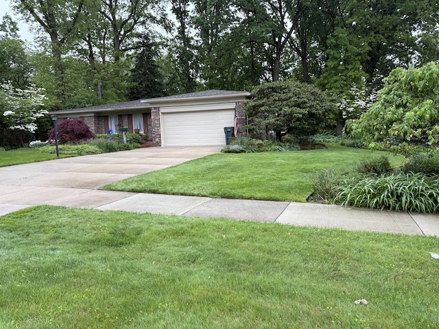 3481 Witherbee Dr, Troy, MI 48084 - view of front of house with concrete driveway, a front yard, an attached garage, and stone siding