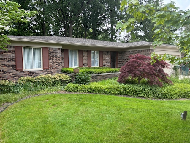 3481 Witherbee Dr, Troy, MI 48084 - single story home with brick siding, a front yard, and an attached garage