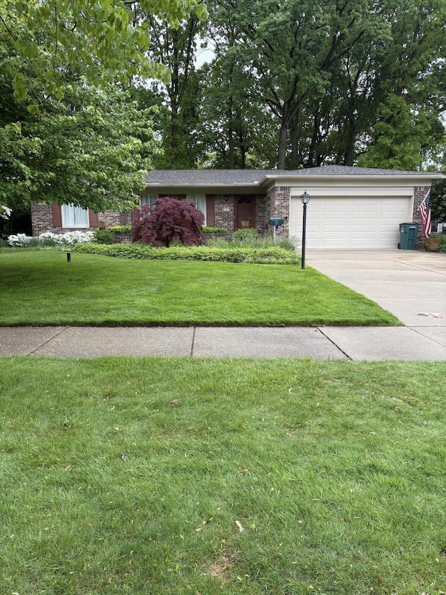 3481 Witherbee Dr, Troy, MI 48084 - view of front of home with a garage, driveway, a front yard, and brick siding