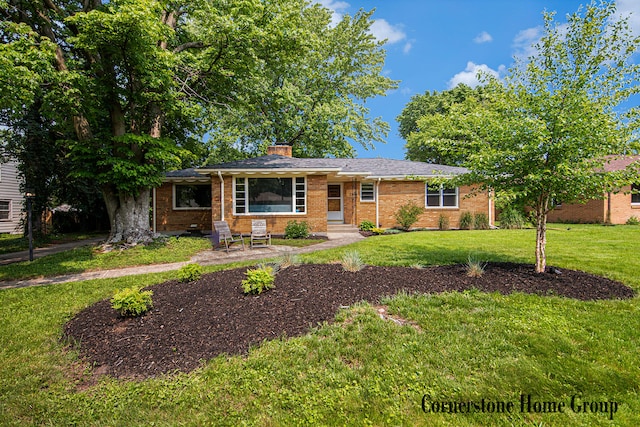 2308 Godwin Ave SE, Grand Rapids, MI 49507 - ranch-style home with a front yard, brick siding, and a chimney