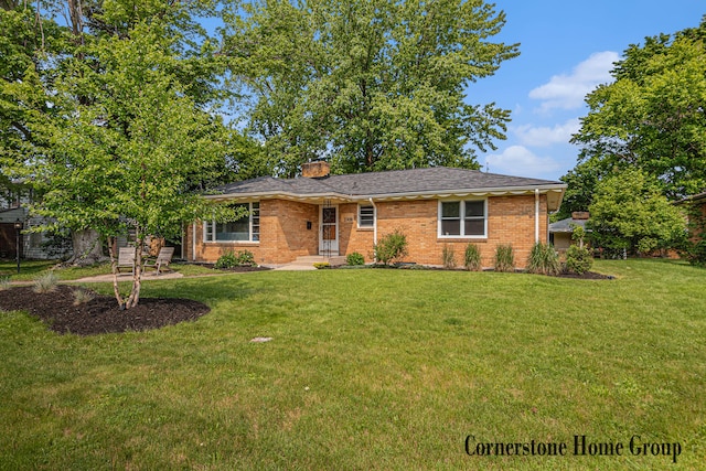 2308 Godwin Ave SE, Grand Rapids, MI 49507 - view of front facade with a front lawn, a chimney, and brick siding