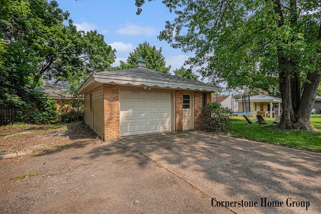 2308 Godwin Ave SE, Grand Rapids, MI 49507 - detached garage featuring a trampoline and driveway