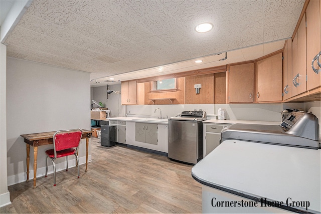 2308 Godwin Ave SE, Grand Rapids, MI 49507 - kitchen with washer / dryer, light countertops, light wood finished floors, and recessed lighting