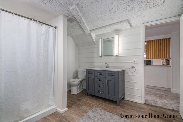 2308 Godwin Ave SE, Grand Rapids, MI 49507 - full bath featuring toilet, vanity, wood finished floors, curtained shower, and baseboards