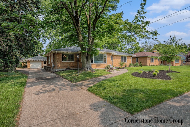 2308 Godwin Ave SE, Grand Rapids, MI 49507 - view of front of house featuring an outdoor structure, driveway, a detached garage, brick siding, and a front lawn