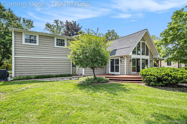 9818 Burning Tree Dr, Grand Blanc, MI 48439 - back of property featuring a deck, a yard, and a shingled roof