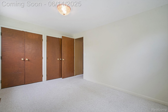 9818 Burning Tree Dr, Grand Blanc, MI 48439 - unfurnished bedroom featuring carpet, multiple closets, and baseboards