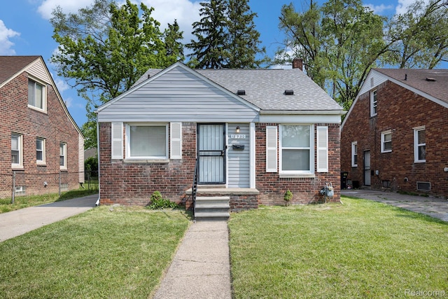 18930 Curtis St, Highland Park, MI 48219 - bungalow featuring a chimney, a front yard, a shingled roof, and brick siding
