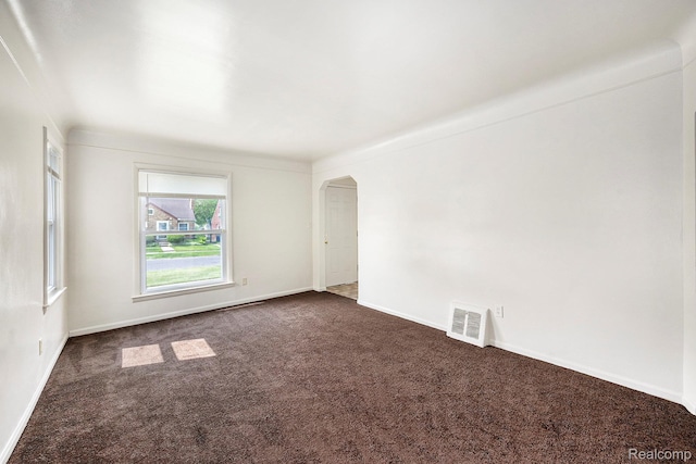 18930 Curtis St, Highland Park, MI 48219 - unfurnished room featuring dark carpet, arched walkways, and baseboards