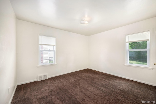 18930 Curtis St, Highland Park, MI 48219 - empty room with dark colored carpet and baseboards