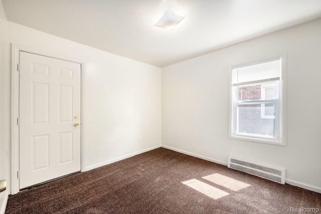 18930 Curtis St, Highland Park, MI 48219 - spare room featuring dark colored carpet and baseboards