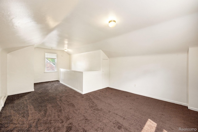 18930 Curtis St, Highland Park, MI 48219 - bonus room with dark colored carpet, lofted ceiling, and baseboards