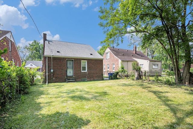18930 Curtis St, Highland Park, MI 48219 - rear view of property with brick siding and a chimney