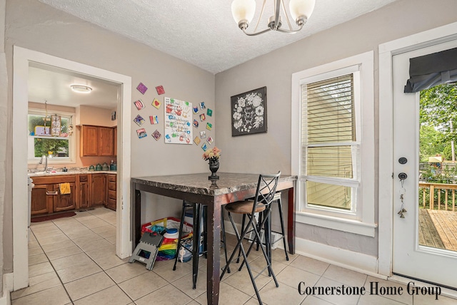 503 E Main St, Middleville, MI 49333 - dining area featuring light tile patterned floors, a chandelier, a textured ceiling, and baseboards