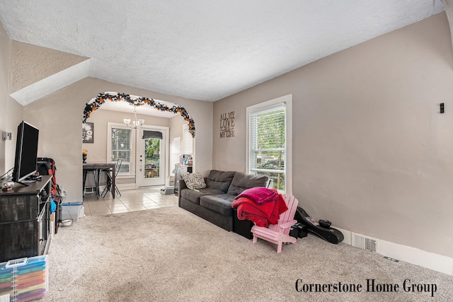 503 E Main St, Middleville, MI 49333 - tiled living area with a chandelier, a textured ceiling, carpet flooring, and baseboards