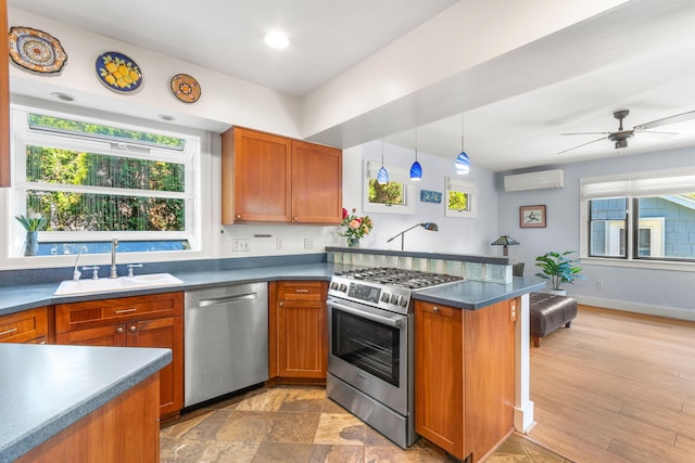 1308 Linwood Ave, Ann Arbor, MI 48103 - kitchen featuring stainless steel appliances, a sink, a wall unit AC, a peninsula, and dark countertops