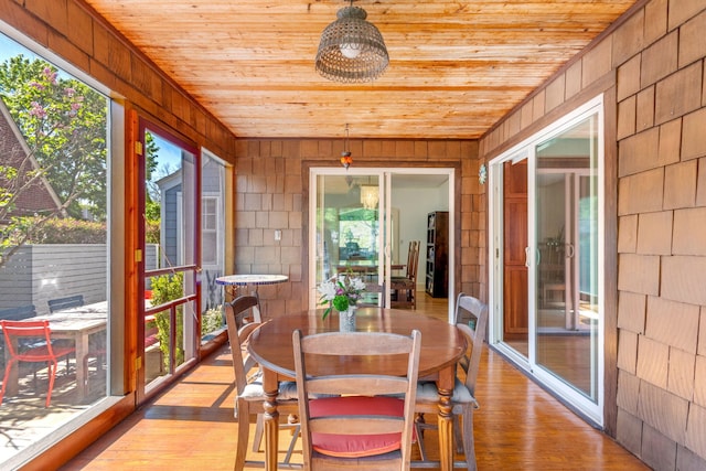 1308 Linwood Ave, Ann Arbor, MI 48103 - sunroom / solarium with wooden ceiling, healthy amount of natural light, wood walls, outdoor dining space, and wood finished floors