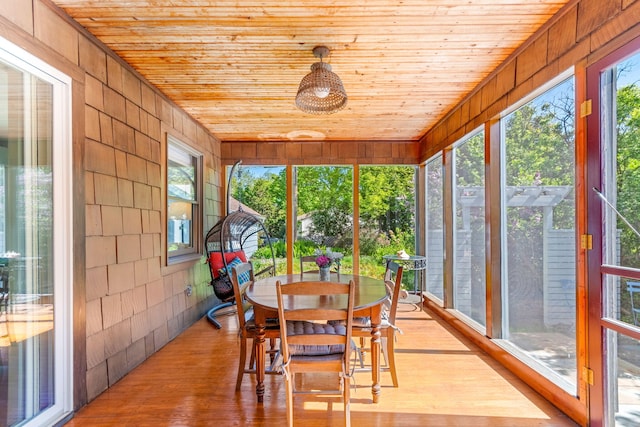 1308 Linwood Ave, Ann Arbor, MI 48103 - sunroom with wooden ceiling, outdoor dining space, wood finished floors, healthy amount of natural light, and wooden walls