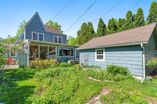 1308 Linwood Ave, Ann Arbor, MI 48103 - back of house with a shingled roof, central air condition unit, a yard, and a sunroom