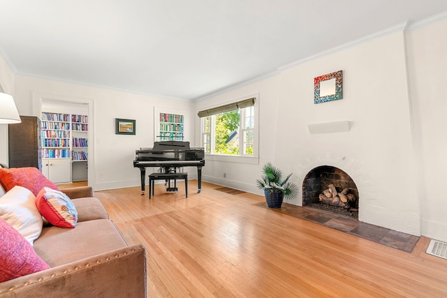1308 Linwood Ave, Ann Arbor, MI 48103 - living area featuring a fireplace with flush hearth, light wood-style floors, ornamental molding, and baseboards