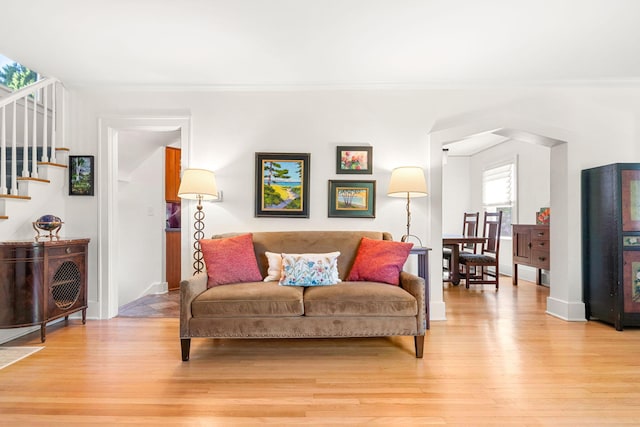 1308 Linwood Ave, Ann Arbor, MI 48103 - living room featuring light wood-style flooring, stairs, ornamental molding, and baseboards