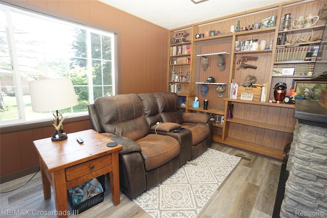 20375 Sumpter Rd, Belleville, MI 48111 - living area with plenty of natural light, wood finished floors, wood walls, and built in features