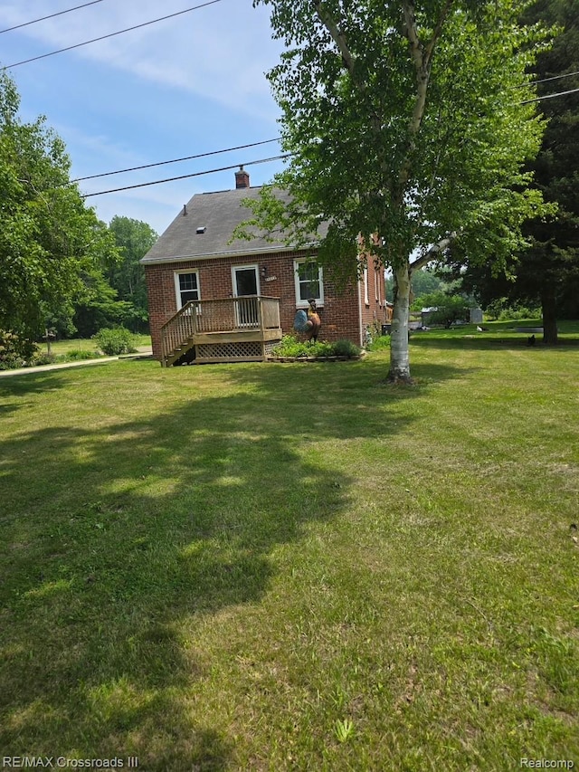 20375 Sumpter Rd, Belleville, MI 48111 - view of front of house featuring a front yard, brick siding, and a chimney
