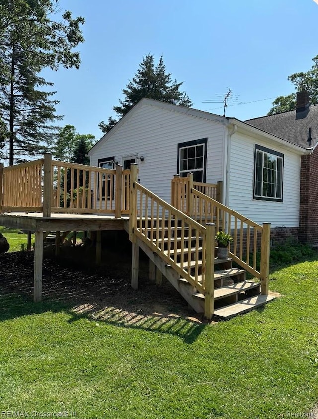 20375 Sumpter Rd, Belleville, MI 48111 - rear view of property with a wooden deck and a lawn