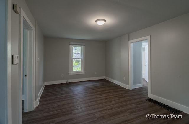 41 Grove St NE, Grand Rapids, MI 49505 - spare room with baseboards and dark wood-type flooring