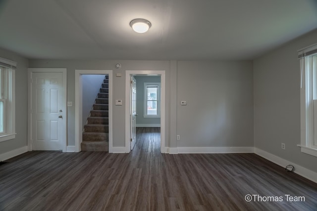 41 Grove St NE, Grand Rapids, MI 49505 - empty room featuring dark wood finished floors, stairway, and baseboards