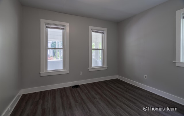 41 Grove St NE, Grand Rapids, MI 49505 - spare room with dark wood-style flooring and baseboards