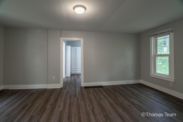 41 Grove St NE, Grand Rapids, MI 49505 - spare room featuring baseboards and dark wood-type flooring