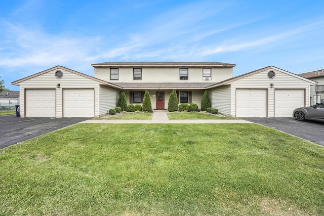 41 E 48th St, Holland, MI 49423 - traditional home featuring a garage, asphalt driveway, and a front lawn