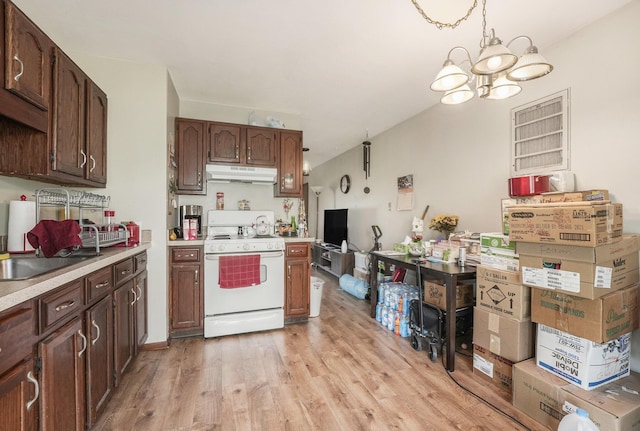 41 E 48th St, Holland, MI 49423 - kitchen featuring electric stove, under cabinet range hood, a chandelier, light wood finished floors, and light countertops