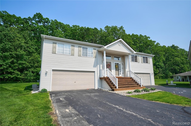1015 Timber Ridge Ct, Grand Blanc, MI 48439 - bi-level home featuring a front lawn, asphalt driveway, and an attached garage