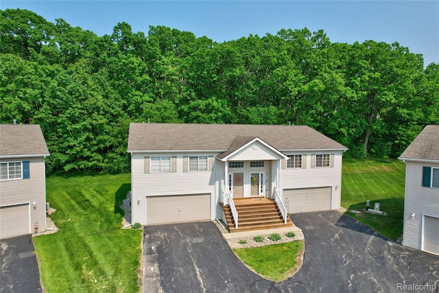 1015 Timber Ridge Ct, Grand Blanc, MI 48439 - split foyer home with asphalt driveway, a front yard, a garage, and french doors
